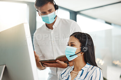 Buy stock photo Covid, face mask and call center woman training intern on customer service computer, contact us and crm consulting office. Virus compliance, receptionist teamwork or learning consultant collaboration