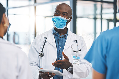 Buy stock photo Covid, healthcare and teamwork with a doctor talking to his team about medicine in the hospital. Research, collaboration and communication with a surgeon working on a tablet in a clinic for health