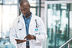 Doctor with tablet, happy reading social media post, text or email from on break at hospital. Black man in healthcare career, on internet to research information on medical science and technology