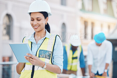 Buy stock photo Construction, building and tablet with a woman architect working in the city on a build site with her team in the background. Engineer, designer and architecture with a young female at work online