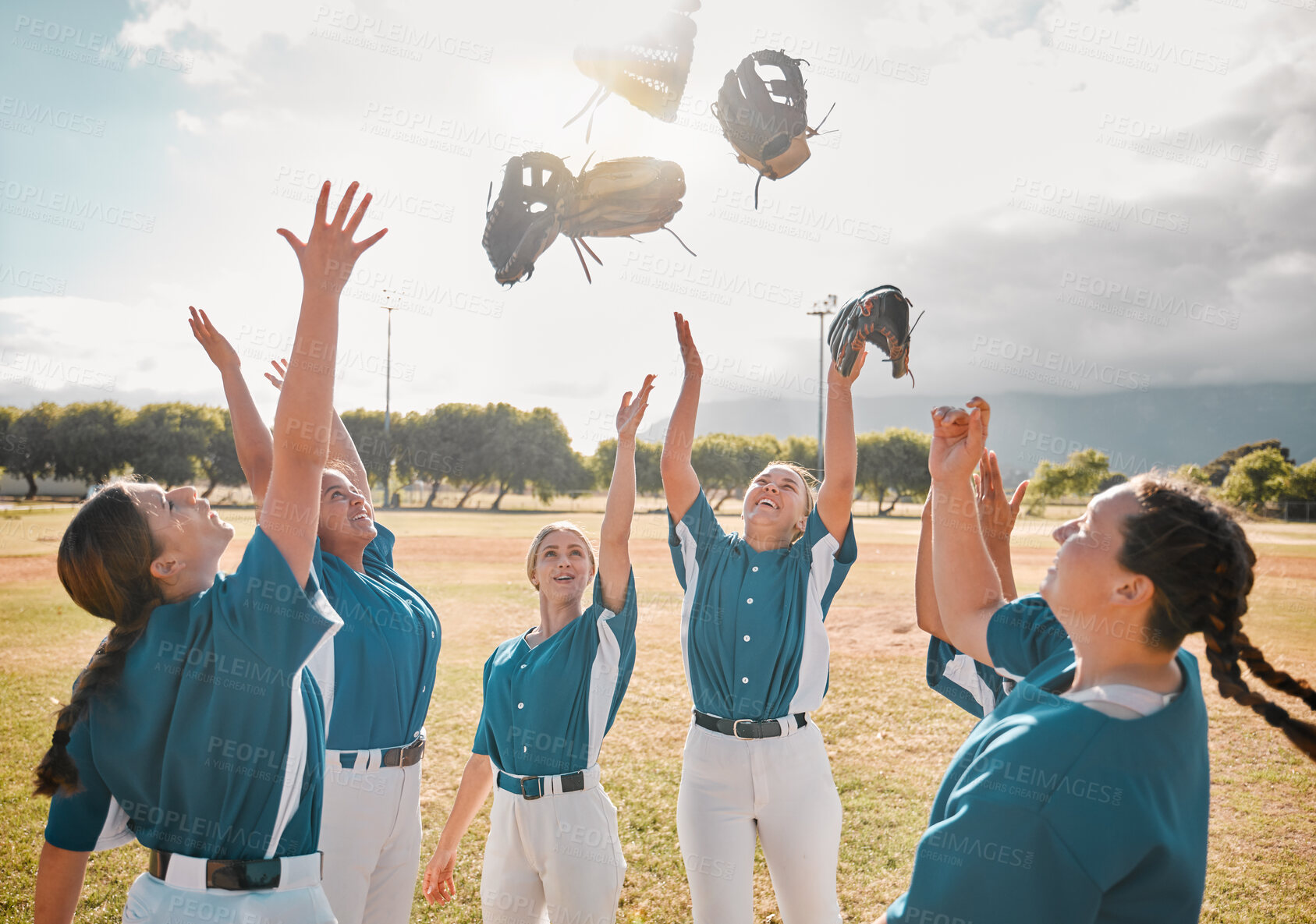 Buy stock photo Baseball, team and women celebration, winner and excited after winning a game and throwing gloves in the air. Teamwork, collaboration and support with happy group on teens in a sports club outdoor