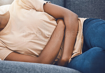 Buy stock photo Stomach pain, sick and woman with endometriosis on the living room sofa in home, sleeping with health problem and sad about medical emergency on couch. Hungry person with tummy cramp in the lounge