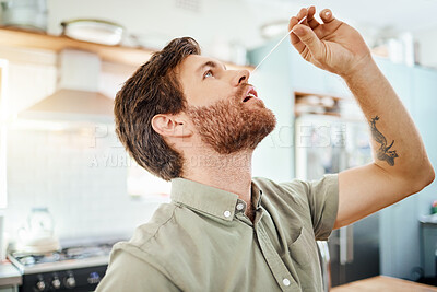 Buy stock photo Covid, sick and man in PCR test at home in the kitchen for self healthcare, wellness and safety. Male practicing safe health testing nose for corona virus in quarantine inspection at the house
