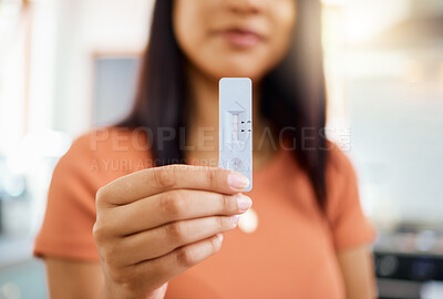 Buy stock photo Rapid antigen test, covid and positive with the hand of a woman holding a testing kit and result in her home. Healthcare, medicine and health with a female in her house infected with the corona virus