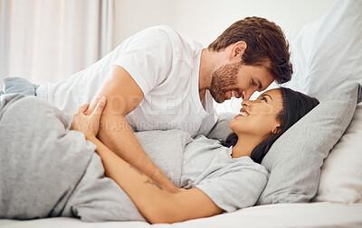 Buy stock photo Love, morning and wake up with couple in bed together for care, communication and happy. Sleeping, relax and smile with young man and woman lying in bedroom for support, marriage and happiness