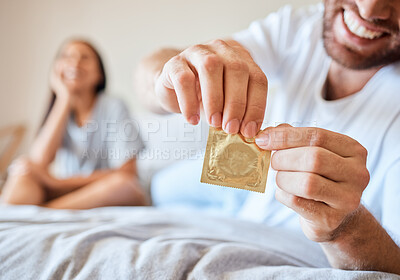 Buy stock photo Condom, sex and safety for sexual couple in bed together happy, smile and use protection. Happiness, love and man and woman open birth control contraceptive package to protect against std, sti or hiv