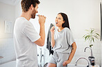 Love, morning and couple in bathroom brushing teeth together doing daily routine, happy and smile. Man and woman with good dental health, mouth care and cleaning teeth with toothbrush and toothpaste