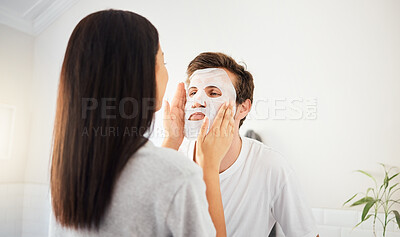 Buy stock photo Couple facial in bathroom, beauty mask cleanser on man face and skincare wellness product. Cosmetic cleaning, young marriage together and beautiful woman showing self love and relax in home together
