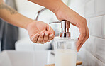 Hand washing, hygiene and soap dispenser with woman in bathroom rinsing with water for corona virus, germs or bacteria prevention. Closeup hands for cleanliness, self care and clean habits for health