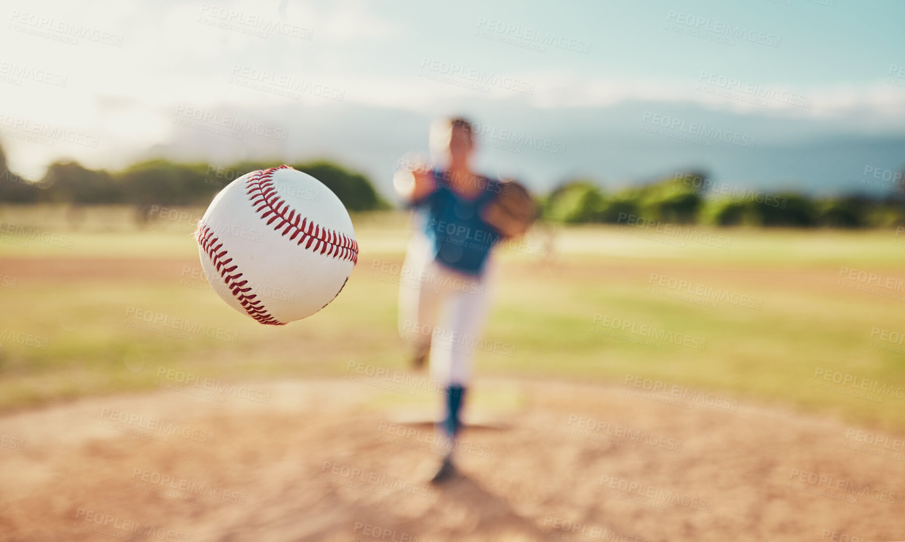 Buy stock photo Baseball, sport and ball with a sports athlete or pitcher throwing and pitching a ball during a game or match on a court. Fitness, workout and exercise with an athletic person training outside