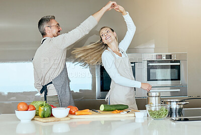 Buy stock photo Dancing couple, cooking and love in the kitchen while preparing vegetables for a healthy, organic and vegan meal or salad. Happy man and woman with energy, joy and good health having fun at home
