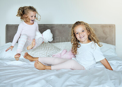Buy stock photo Happy, sisters and bed smile of little girls in playful joy and happiness together at home. Kids, sibling love and care for joyful relationship or friendship having fun in the bedroom