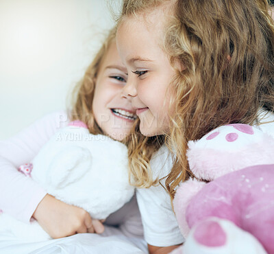 Buy stock photo Children, love and twin sisters playing together holding teddy bear toys while lying comfortable sharing family or sibling bond at home. Happy, family and caring girls and friends in bed for fun