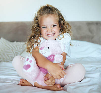 Buy stock photo Children, teddy bear and girl child hug her stuffed animal with a smile in her house. Portrait of kid, happy and safe with an adorable or cute female holding a fluffy toy sitting on a bed