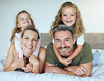 Family smile, happy portrait and children giving love hug to parents, happy on holiday vacation and relax on bed in home. Mother and father with happiness in bedroom with kids in the morning