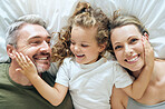 Family, happy and smile of people in bed at home feeling relax in a bedroom bonding. Mother, girl and man with happiness together in a house with love, care and calm smiling with a positive mindset