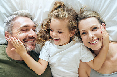 Buy stock photo Family, happy and smile of people from above in bed at home relax in a bedroom. Mother, girl and man with happiness together in a house with love, care and calm smiling with a positive mindset