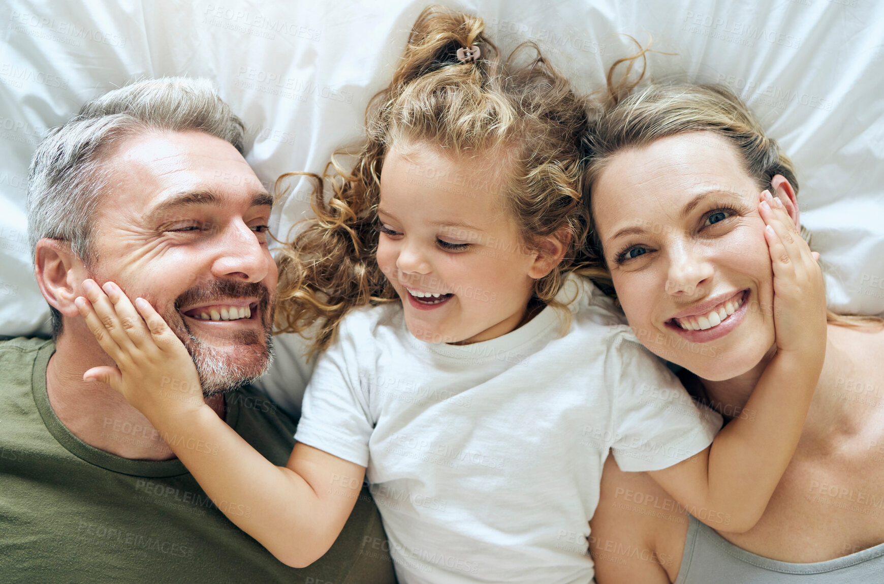 Buy stock photo Family, happy and smile of people from above in bed at home relax in a bedroom. Mother, girl and man with happiness together in a house with love, care and calm smiling with a positive mindset