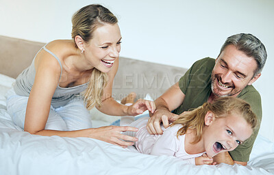 Buy stock photo Happy family, bed and fun family playing and laughing while relaxing with little girl in a bedroom. Happy, playful and loving parents being silly with excited child, enjoying free time in their home