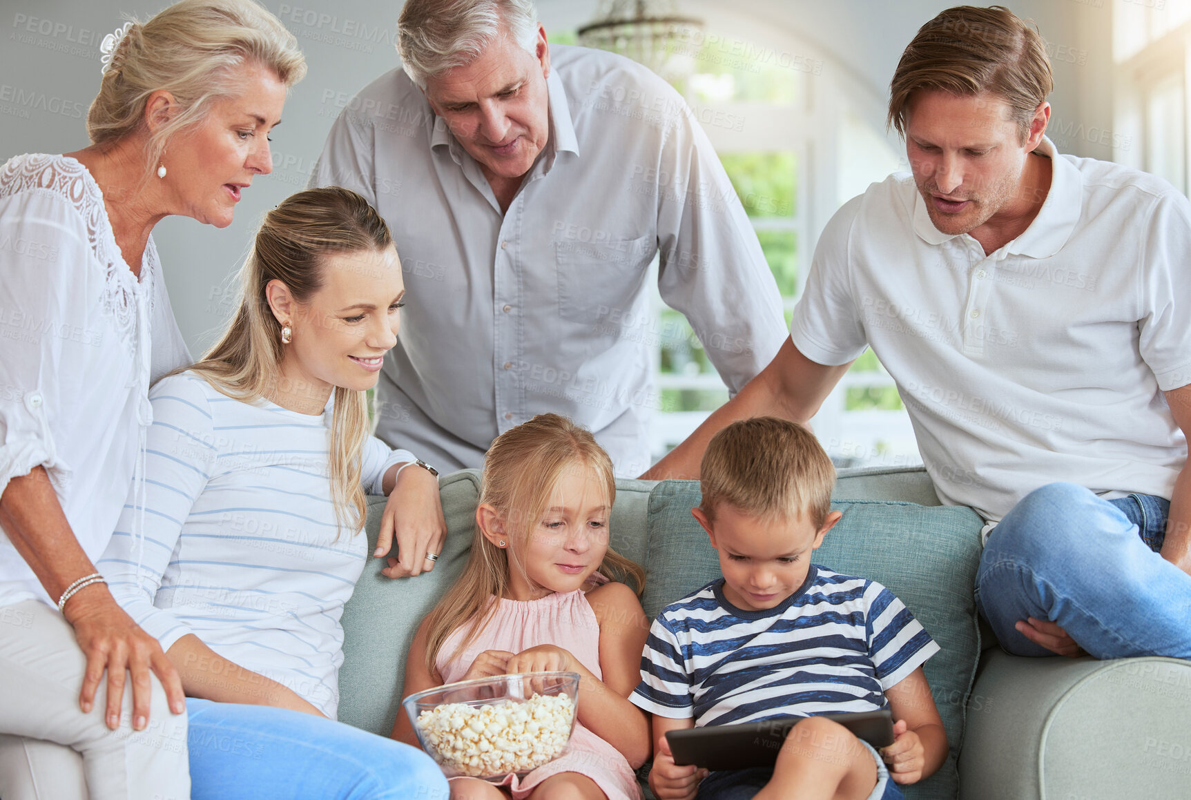 Buy stock photo Streaming, media and family watch tablet movies entertainment on internet mobile app together in living room. Happy family people love watching online reunion film series on technology in home lounge