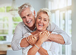 Love, couple and retirement with a senior man and woman looking happy and hugging in their home together. Smile, romance and relationship with an elderly male and female pensioner in a house
