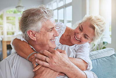 Buy stock photo Love, happy and senior couple hug and bonding on sofa, smile and relax in home together. Retirement, freedom and happy man and woman sharing a romantic embrace, enjoying conversation and relationship