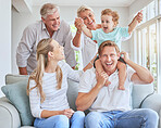 Children, family and baby with parents and a child at his grandparents for a visit while sitting on a sofa in the living room. Kids, happy and smile with a senior man and woman at home with relatives