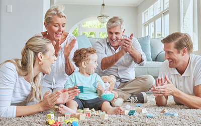 Buy stock photo Family, clapping hands and baby playing with toys while sitting on the living room floor. Love, care and happy people cheering for child development, learning and growth while bonding in the lounge.