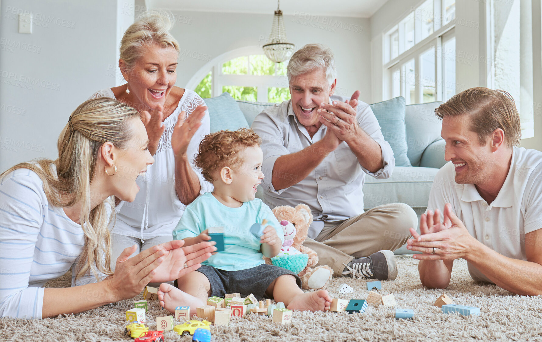 Buy stock photo Family, clapping hands and baby playing with toys while sitting on the living room floor. Love, care and happy people cheering for child development, learning and growth while bonding in the lounge.