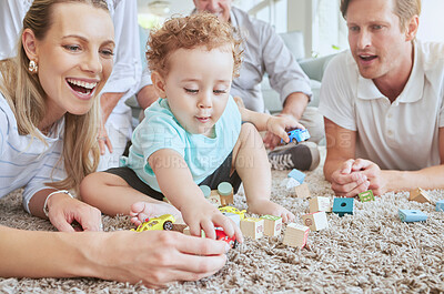 Buy stock photo Big family in living room with baby play with toys and fun together on floor on a weekend. Happy grandparents, mother and father with boy for development in their family home sitting on the ground