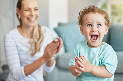 Buy stock photo Happy, clapping hands and mother and son playing in the living room of their family home. Happiness, love and energy of parent and toddler having fun and cheering together in the lounge of a house.