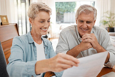 Buy stock photo Happy couple, reading and paperwork or document for bill, mortgage or retirement plan or payout while sitting at home. Mature man and woman busy with tax compliance or finance form for pensioners