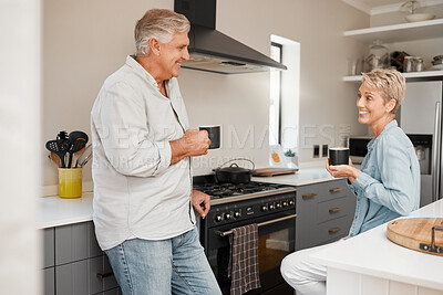 Buy stock photo Senior couple, coffee and talking in kitchen with mug, beverage or drink at home. Retirement, smile and elderly happy man and woman drinking tea speaking, discussion or communication in house.