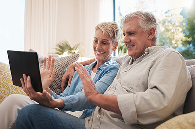 Buy stock photo Senior couple digital tablet, wave and video call with a talking on the sofa in the living room. Video conference  with elderly man and woman smile, happy and conversation online with virtual chat