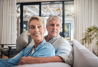 Buy stock photo Thinking, future and senior couple sitting on the sofa at home dreaming about a carefree retirement together to relax and find peace. Mature man and woman looking away enjoying wellbeing and love
