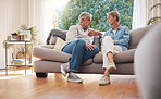 Senior couple, serious talk and communication about problems and marriage issues while sitting on the sofa at home. Mature man and woman talking, arguing and discussing issues, trouble and divorce