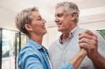 Elderly, happy and dancing couple in living room, enjoying retirement. Portrait of senior man and woman together in their home, smiling, loving and romantic. Family, love and old people having fun