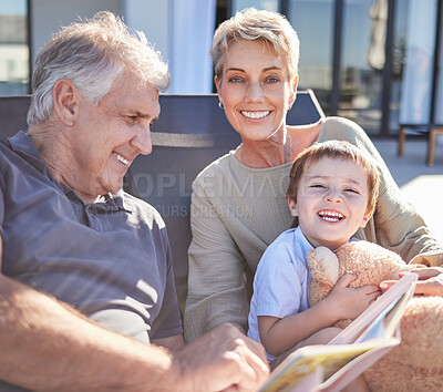 Buy stock photo Happy senior grandparents reading book with child for a summer holiday, memory and relaxing family. Smile, retirement and elderly grandmother with husband outdoors in backyard enjoying quality time
