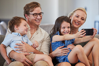 Buy stock photo Family selfie, live streaming phone and girl on the internet with technology, smile for mobile app and record video for web on the sofa in living room. Mother and father taking photo with kids
