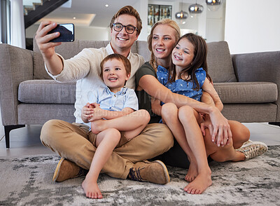Buy stock photo Selfie, phone and family with a man taking a picture with his children and their mother on the floor of their living room at home. Happy, love and kids with a brother and sister posing with parents