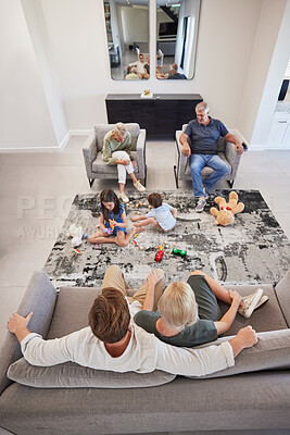Buy stock photo Family, relax and children playing with toys on the floor in the living room while bonding. Calm grandparents and parents resting while watching the kids play together in the lounge of their home.