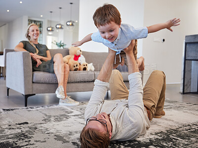 Buy stock photo Family helicopter, child game and father with energy to relax with kid, love with care on the floor and funny in living room together in home. Happy dad and boy playing flying game in the lounge