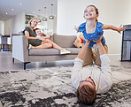 Dad, play and girl in the living room with boy and mom on the sofa in the living room. Trust, love and support as happy child having fun, laugh and joy with her family in home lounge together
