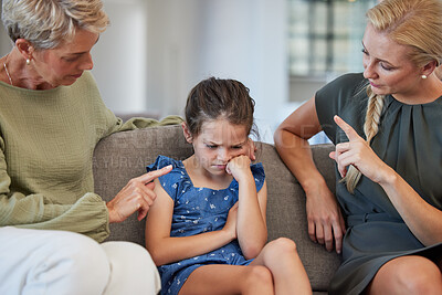 Buy stock photo Family, discipline and warning by mother and grandmother hand sign to girl for bad behaviour on a sofa at home. Autism, adhd and communication by parent and daughter in conflict with attitude problem