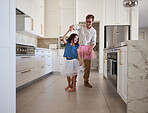 Happy family, dance and kitchen with father and daughter having fun, playing and enjoy freedom at home. Creative parent dressing up and dancing to support and encourage his daughter ballet hobby