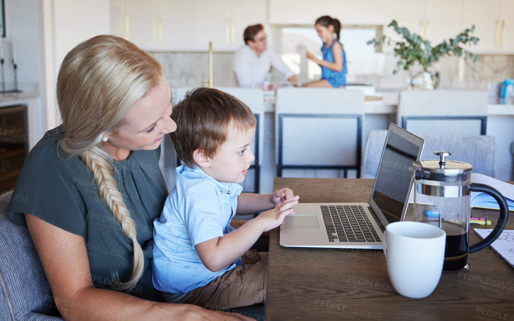 Buy stock photo Mother, kid and laptop at table in living room with father and girl in background. Work from home mom on coffee break with son. Child development, family time and relax, a mothers love for children