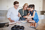 Family, girl and baking in house kitchen or home interior for health food, bread product or wellness breakfast pancakes. Smile, happy and bonding man and woman or mother and father cooking with child