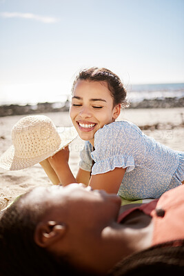 Buy stock photo Summer, beach fun and female friends lying on the sand while talking, laughing and relax on a seaside vacation together. Diversity, friendship and bond between women on holiday with fun in the sun