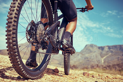 Buy stock photo Bicycle, sport and wheels on a dirt road adventure trail on a mountain for fitness and exercise. Closeup of a bike, track and an athlete turning the tire in sand while cycling in nature for fun.