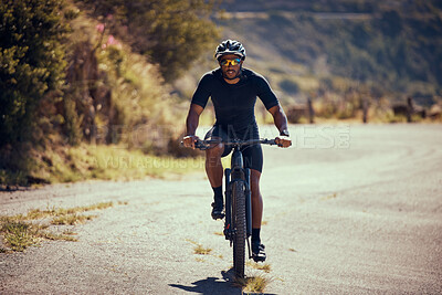 Buy stock photo Fitness, mountain and man cycling on a bicycle in summer for exercise, training and cardio workout on the road. Lifestyle, wellness and strong cyclist enjoys riding his mountain bike alone outdoors